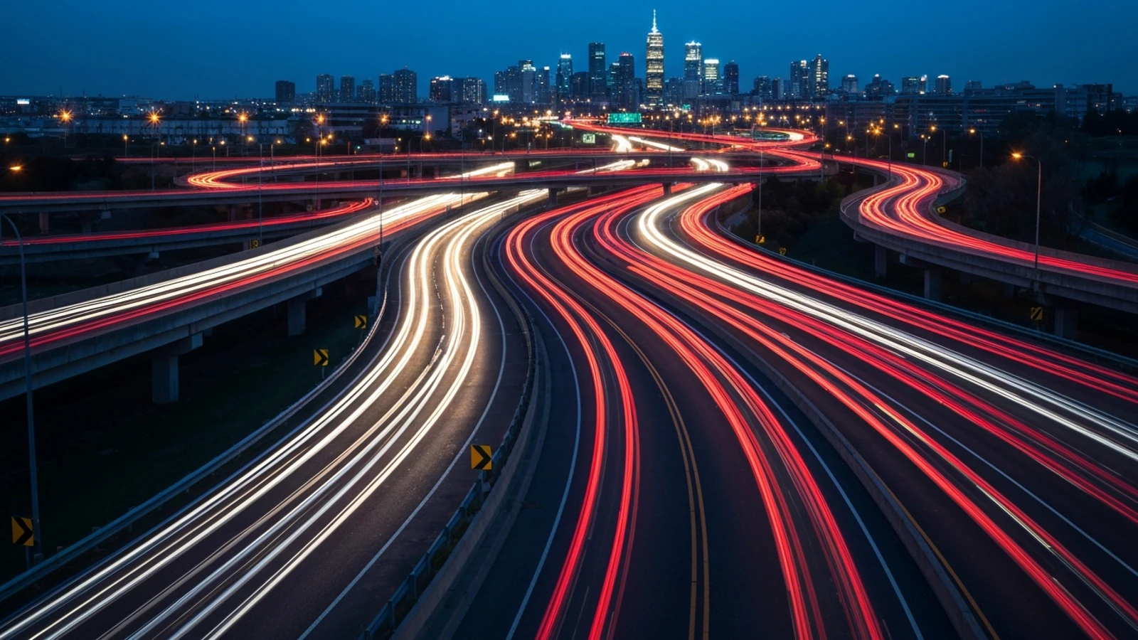 A wide highway interchange at dusk with light trails, representing multi-state coverage