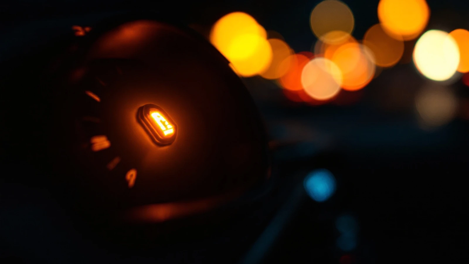 A dimly lit instrument cluster with a security telltale illuminated and the engine not running